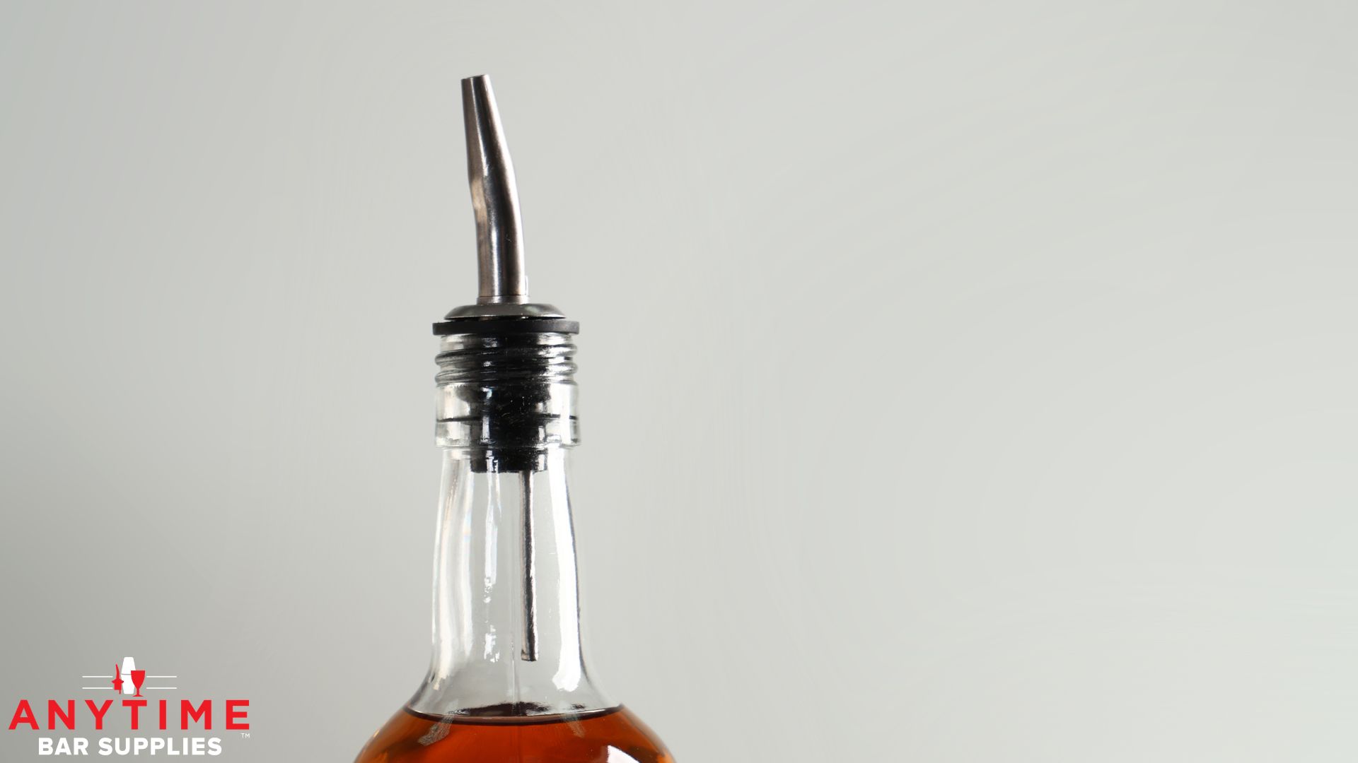 close up of a stainless steel pour spout on a liquor bottle - Anytime Bar Supplies bulk pourers for bars