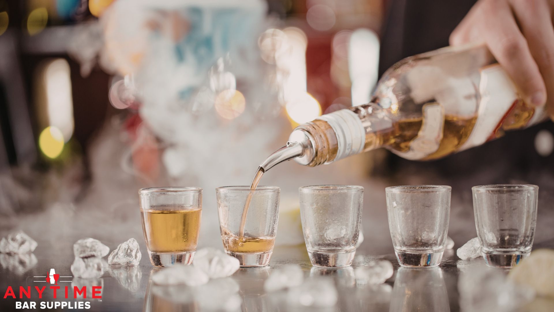 bartender pouring liquor from a stainless steel pour spout - Anytime Bar Supplies professional liquor pourers